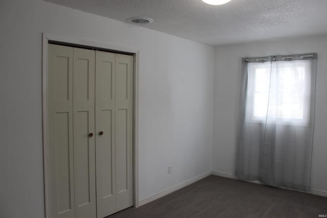 308 Clyde Ave, Angola, IN 46703 - unfurnished bedroom featuring a textured ceiling, visible vents, baseboards, and a closet