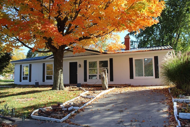 308 Clyde Ave, Angola, IN 46703 - ranch-style house featuring a chimney, metal roof, and a front yard