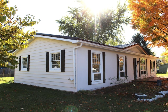 view of home's exterior with a yard