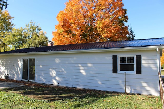 view of side of property with a yard