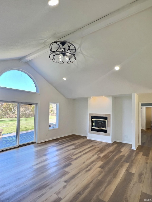 unfurnished living room with beamed ceiling, wood-type flooring, and high vaulted ceiling