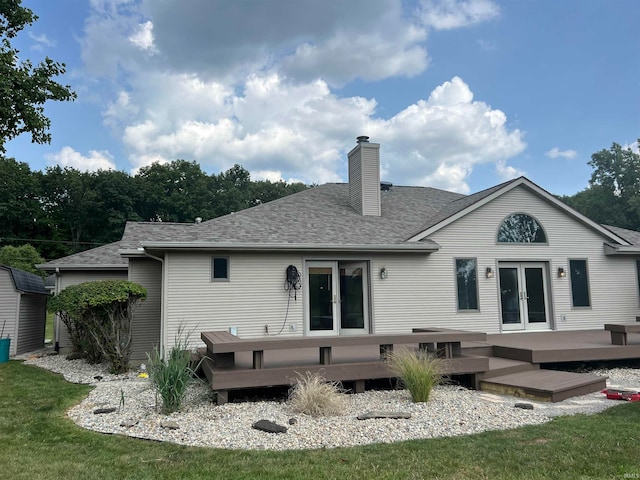 rear view of house featuring a yard and a wooden deck