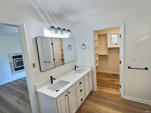 bathroom featuring vanity, a textured ceiling, and hardwood / wood-style flooring