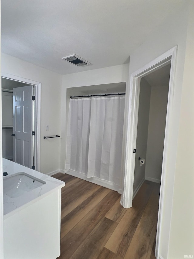 bathroom featuring wood-type flooring and sink