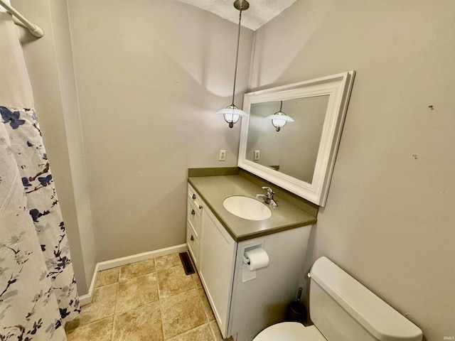 bathroom featuring vanity, toilet, and a textured ceiling