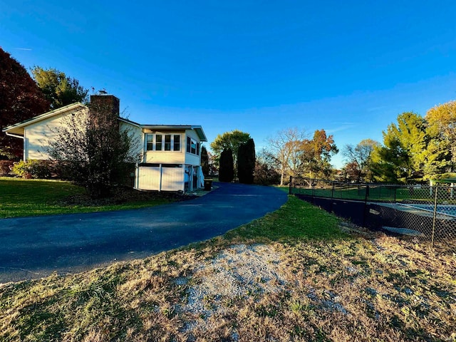 view of home's exterior featuring a yard and a garage