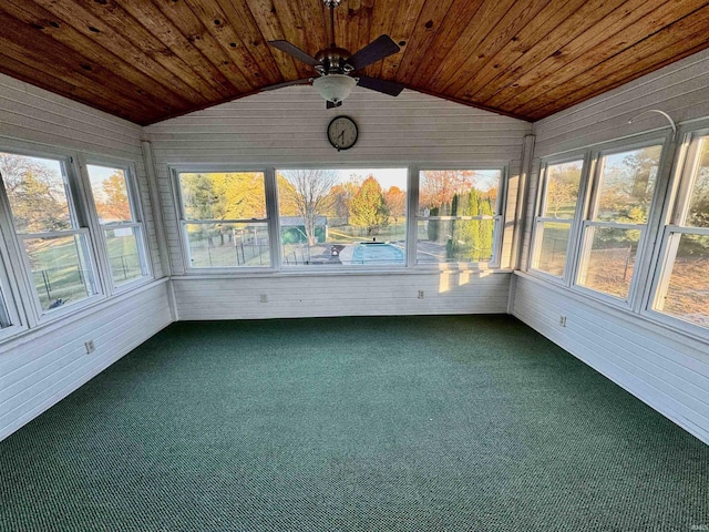 unfurnished sunroom featuring a wealth of natural light, vaulted ceiling, ceiling fan, and wooden ceiling