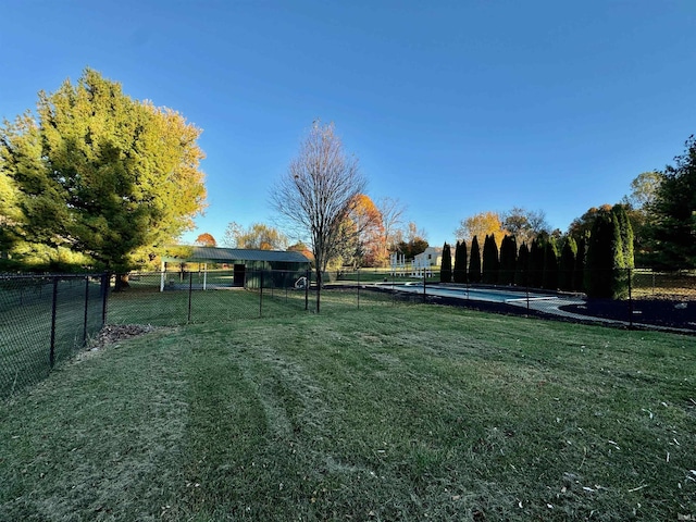 view of yard featuring a fenced in pool and fence