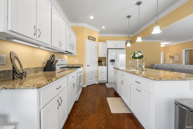 kitchen featuring white cabinets, dark hardwood / wood-style flooring, white appliances, and a kitchen island with sink