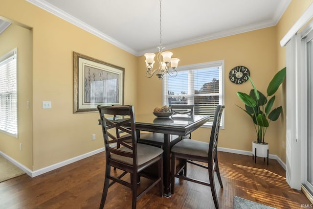 dining space featuring dark hardwood / wood-style flooring, an inviting chandelier, and ornamental molding