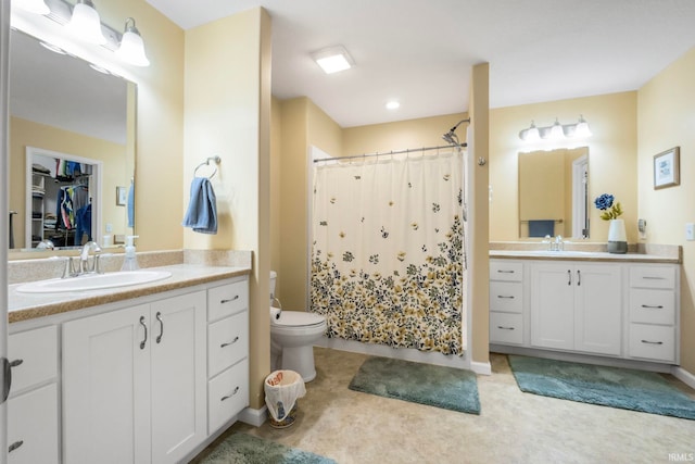 bathroom with curtained shower, vanity, and toilet