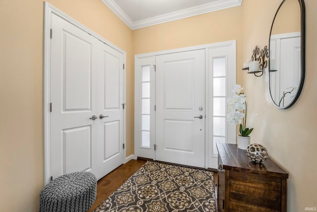 foyer with plenty of natural light, hardwood / wood-style floors, and ornamental molding