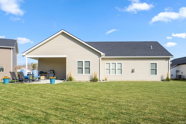 back of house with a patio area, a yard, and central AC