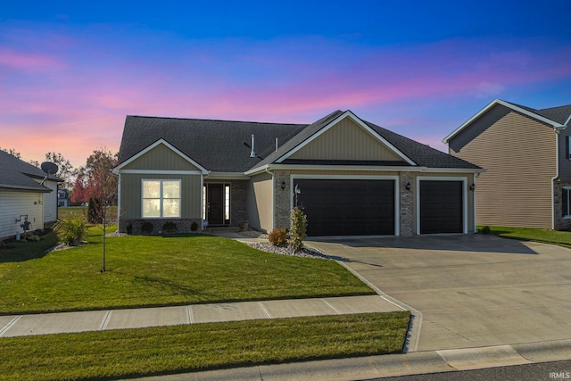 view of front facade featuring a lawn and a garage