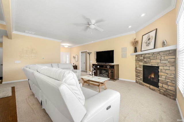 carpeted living room featuring ceiling fan, ornamental molding, and a fireplace