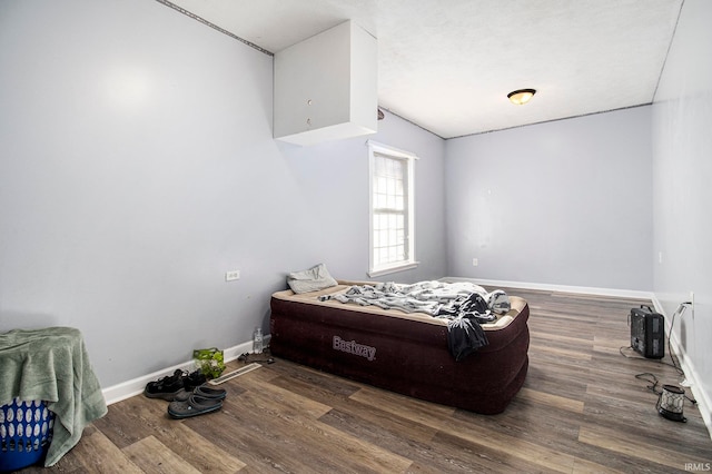 bedroom with dark wood-type flooring