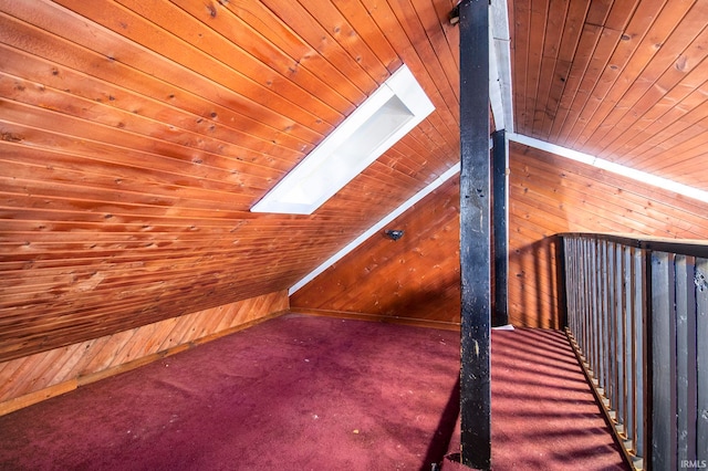 additional living space with carpet flooring, wooden walls, and wooden ceiling