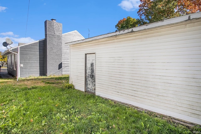 view of side of home featuring a lawn