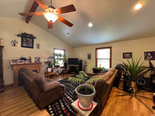 living room featuring ceiling fan, high vaulted ceiling, beam ceiling, and light hardwood / wood-style flooring