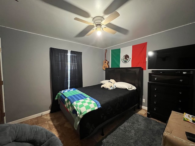 tiled bedroom featuring ceiling fan