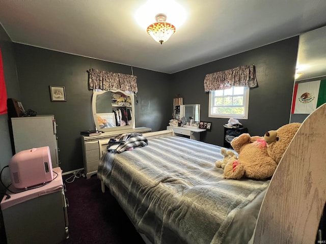 bedroom featuring dark carpet