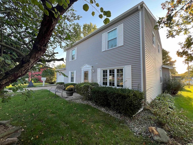 rear view of house featuring a yard