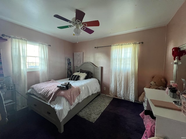 bedroom with ceiling fan and carpet floors