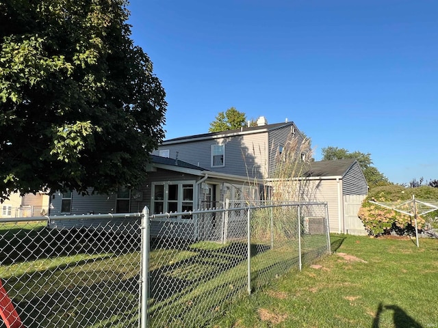 rear view of house with a lawn