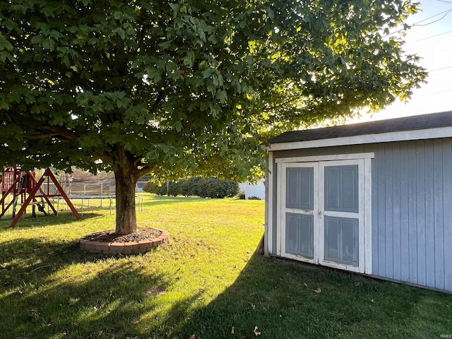 view of yard with a shed and a playground