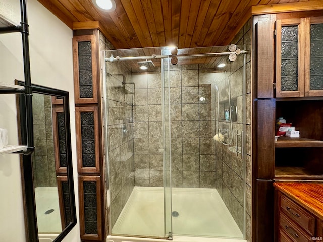 bathroom featuring a shower with door and wood ceiling