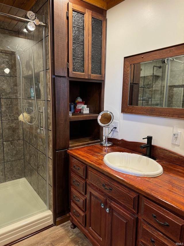 bathroom featuring vanity, hardwood / wood-style flooring, and walk in shower