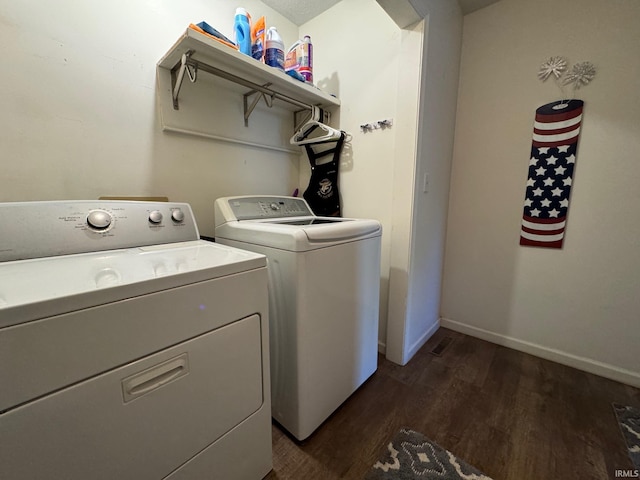 washroom with independent washer and dryer and dark hardwood / wood-style flooring