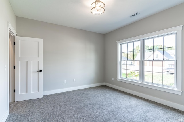 unfurnished room featuring carpet