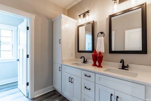 bathroom with vanity and hardwood / wood-style flooring