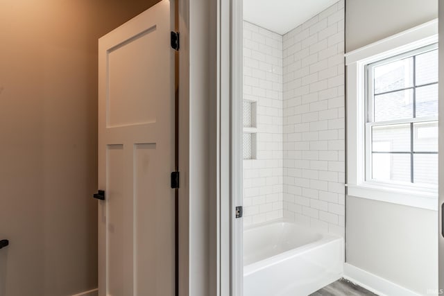 bathroom featuring tiled shower / bath