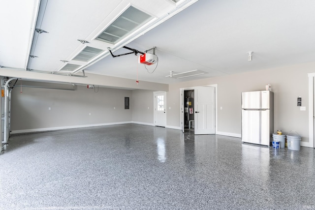 garage with a garage door opener, electric panel, and stainless steel refrigerator