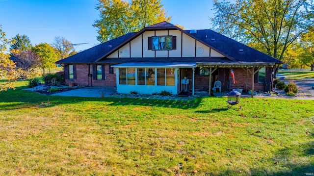 back of house featuring a patio and a lawn