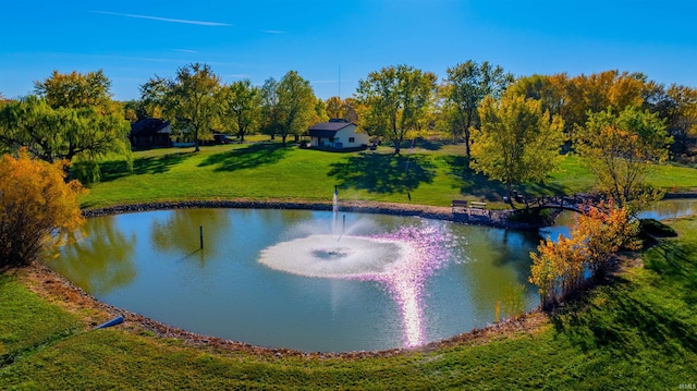 view of property's community featuring a water view and a yard