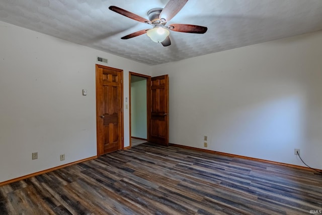 spare room featuring a textured ceiling, dark hardwood / wood-style floors, and ceiling fan