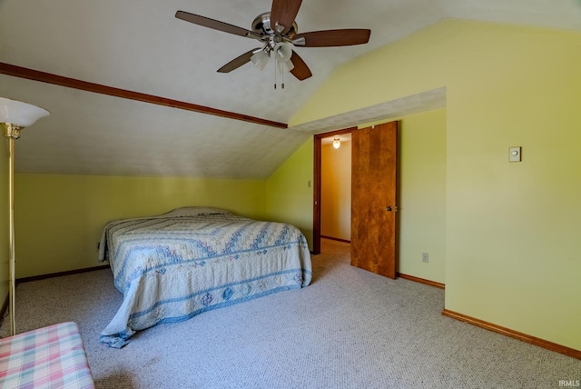 bedroom featuring ceiling fan, vaulted ceiling, and light colored carpet