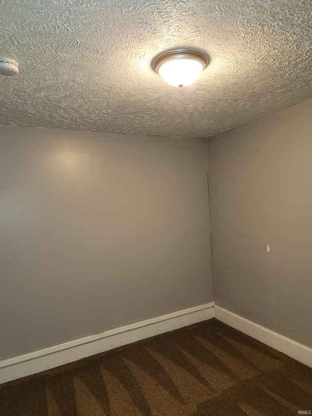 carpeted spare room featuring a textured ceiling