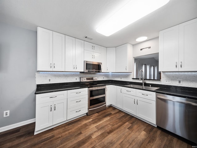 kitchen featuring sink, white cabinetry, and stainless steel appliances