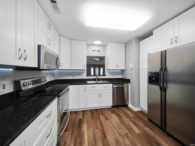 kitchen featuring white cabinetry, stainless steel appliances, dark wood-type flooring, and sink