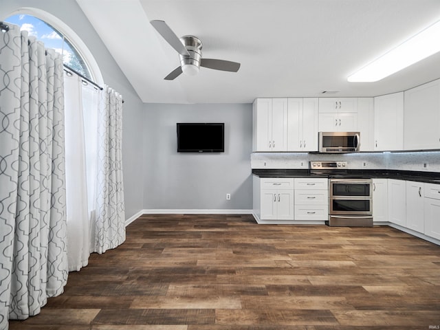 kitchen featuring dark wood-type flooring, ceiling fan, stainless steel appliances, and white cabinets