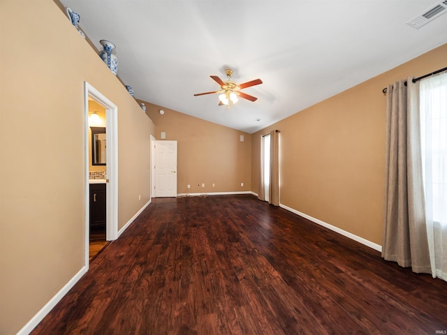 spare room featuring ceiling fan, vaulted ceiling, and dark hardwood / wood-style flooring