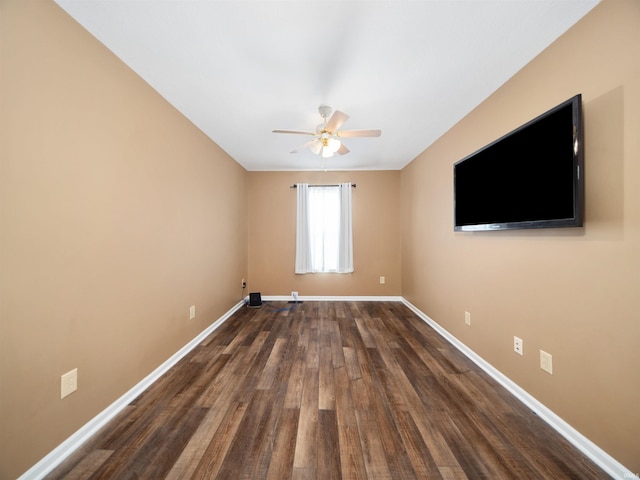 unfurnished room with ceiling fan and dark hardwood / wood-style flooring