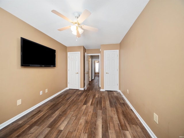 unfurnished bedroom with dark wood-type flooring and ceiling fan