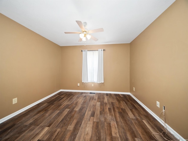 unfurnished room featuring dark wood-type flooring and ceiling fan