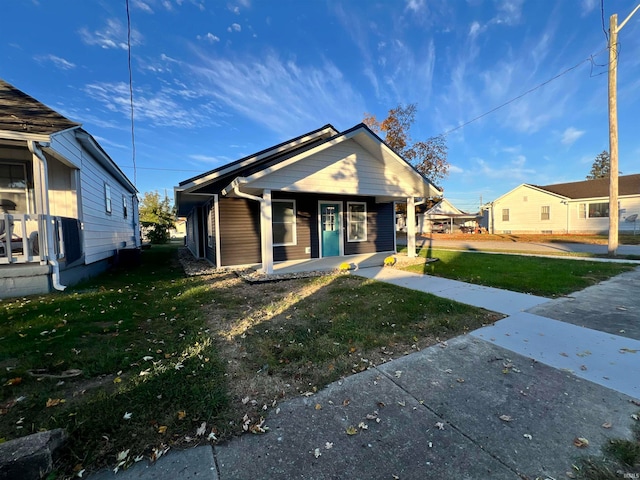 bungalow-style house with a front yard and a porch