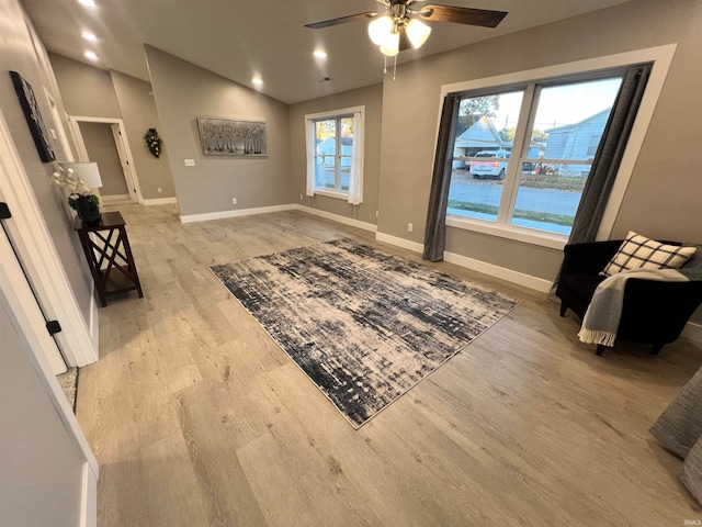 interior space with vaulted ceiling, light hardwood / wood-style flooring, and ceiling fan